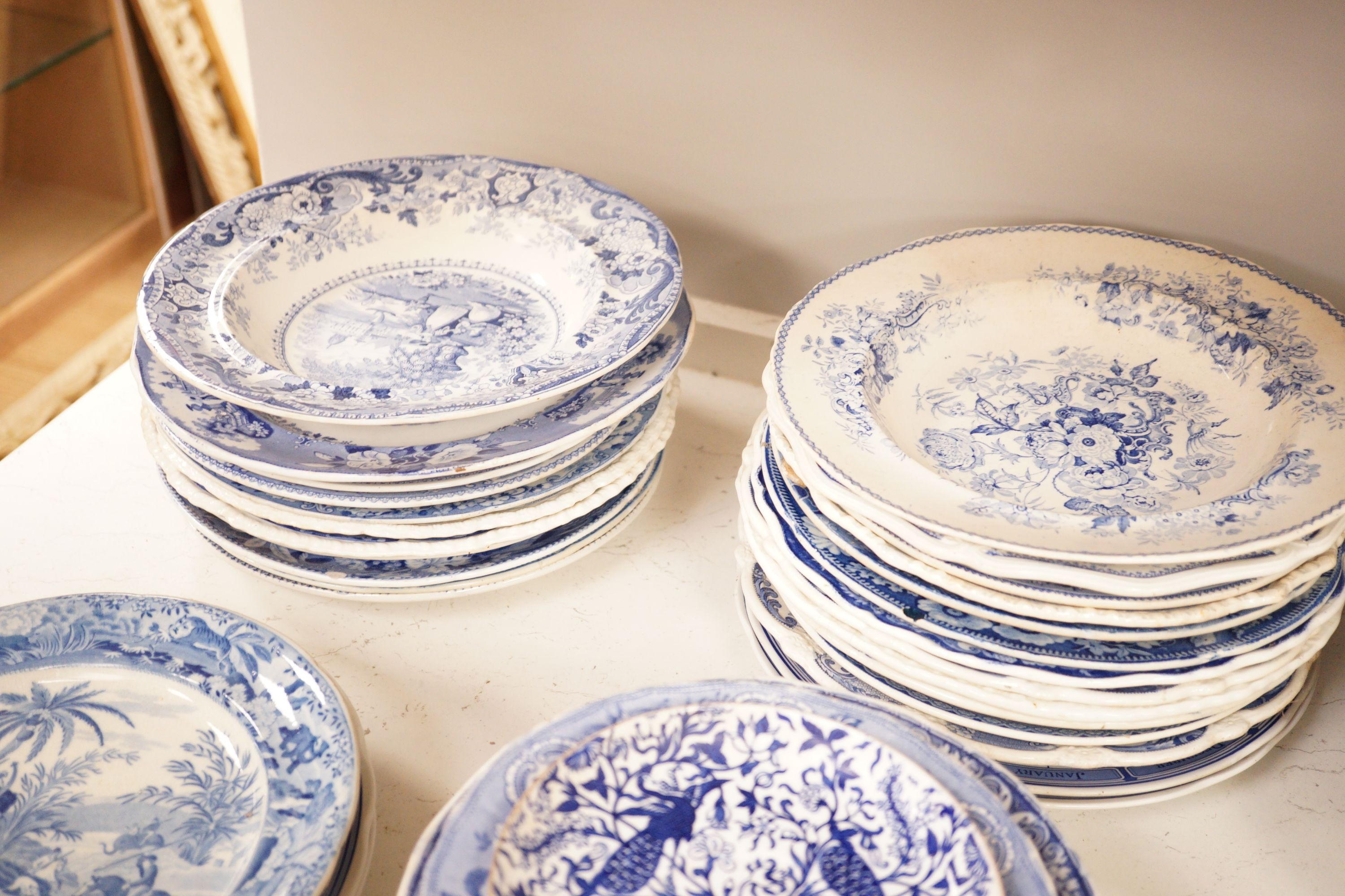 A collection of mostly 19th century blue and white transfer printed pottery tablewares
